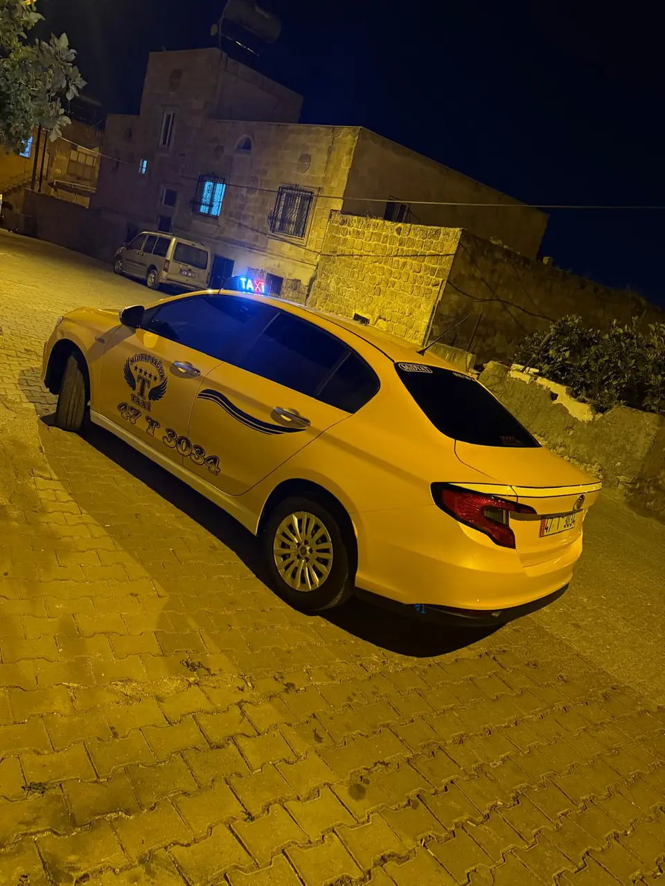 Gece tarihi taş sokakta sarı taksi